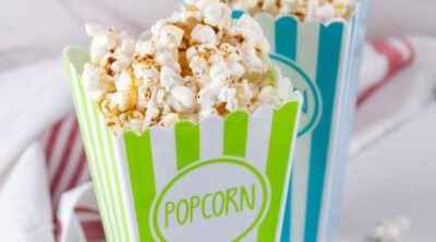 square crop of two brightly colored containers of popcorn.
