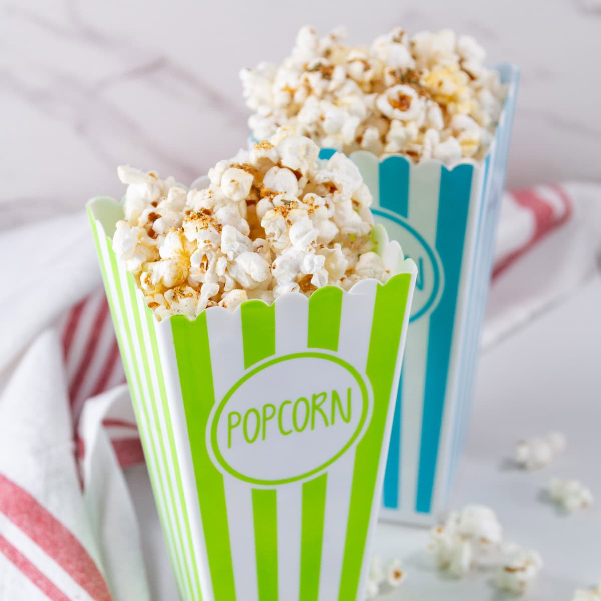 square crop of two brightly colored containers of popcorn.
