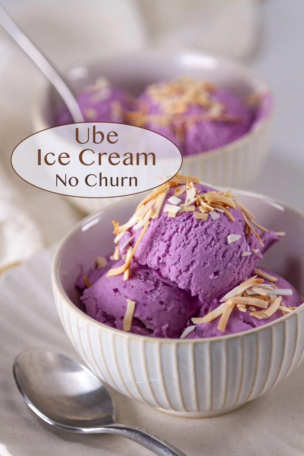 two bowls of ube ice cream with toasted coconut on top.