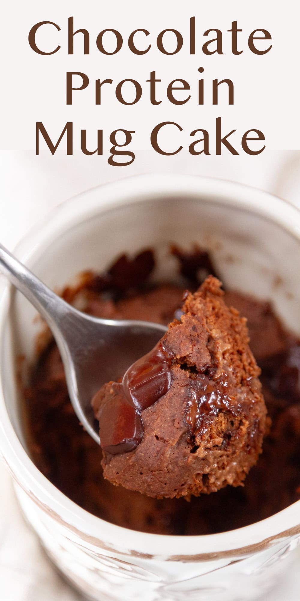 a spoonful of cake being taken out of the mug.