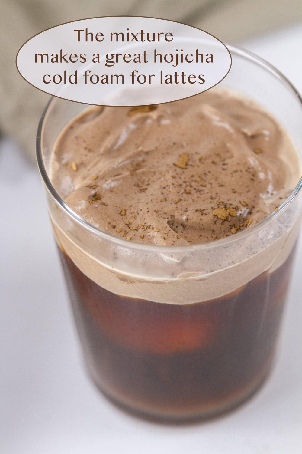iced coffee topped with hojicha cold foam.