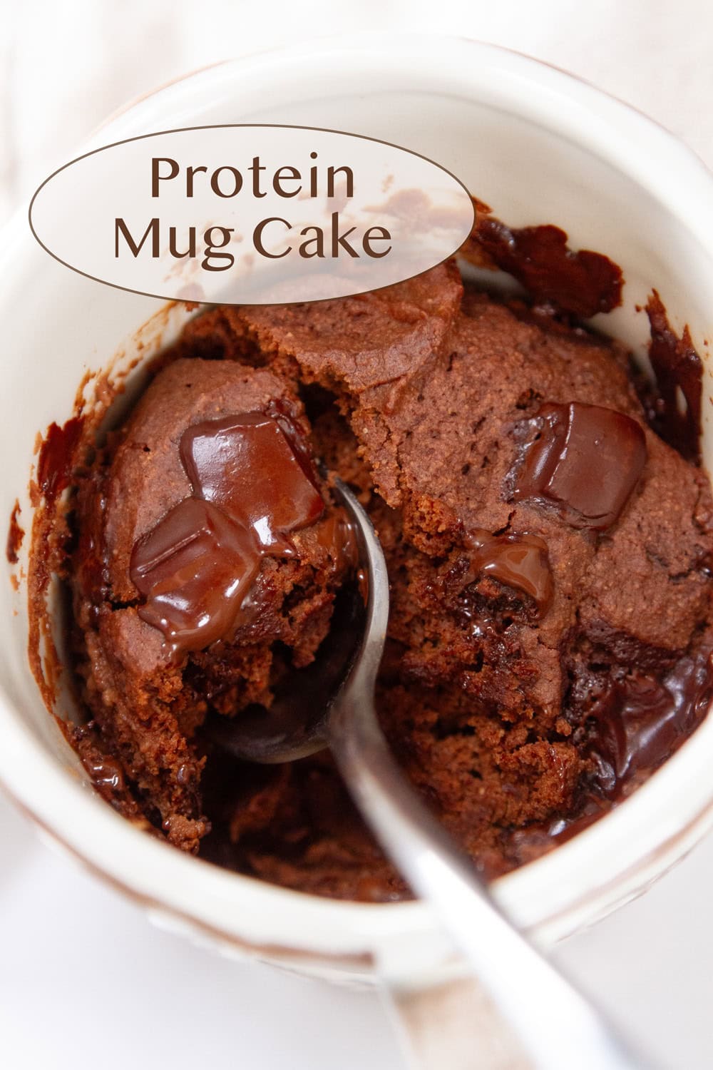 a chocolate mug cake with a spoon in it.
