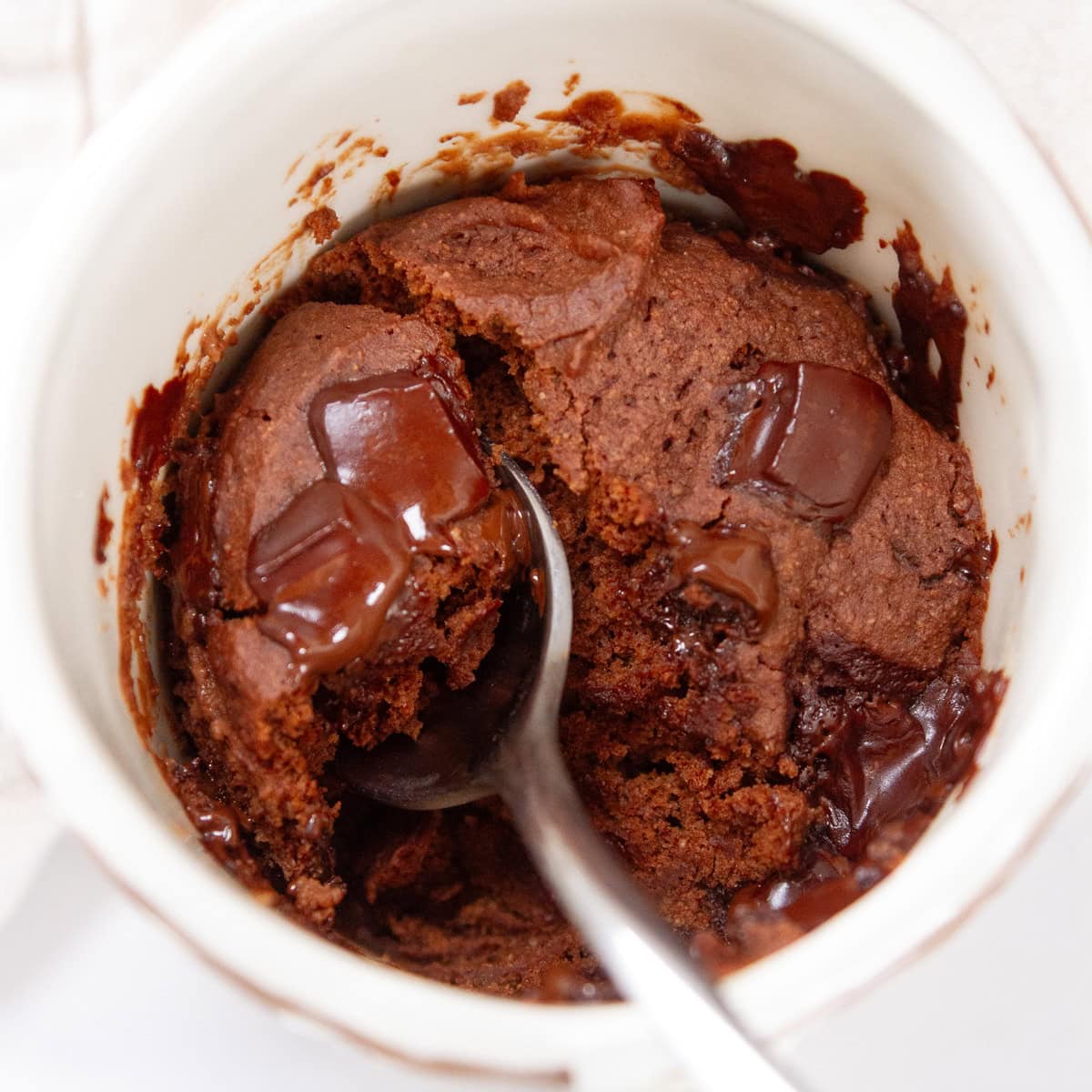 square crop looking down into a white mug filled with mug cake.