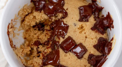 square crop of a mug cake with a bite taken out of it.