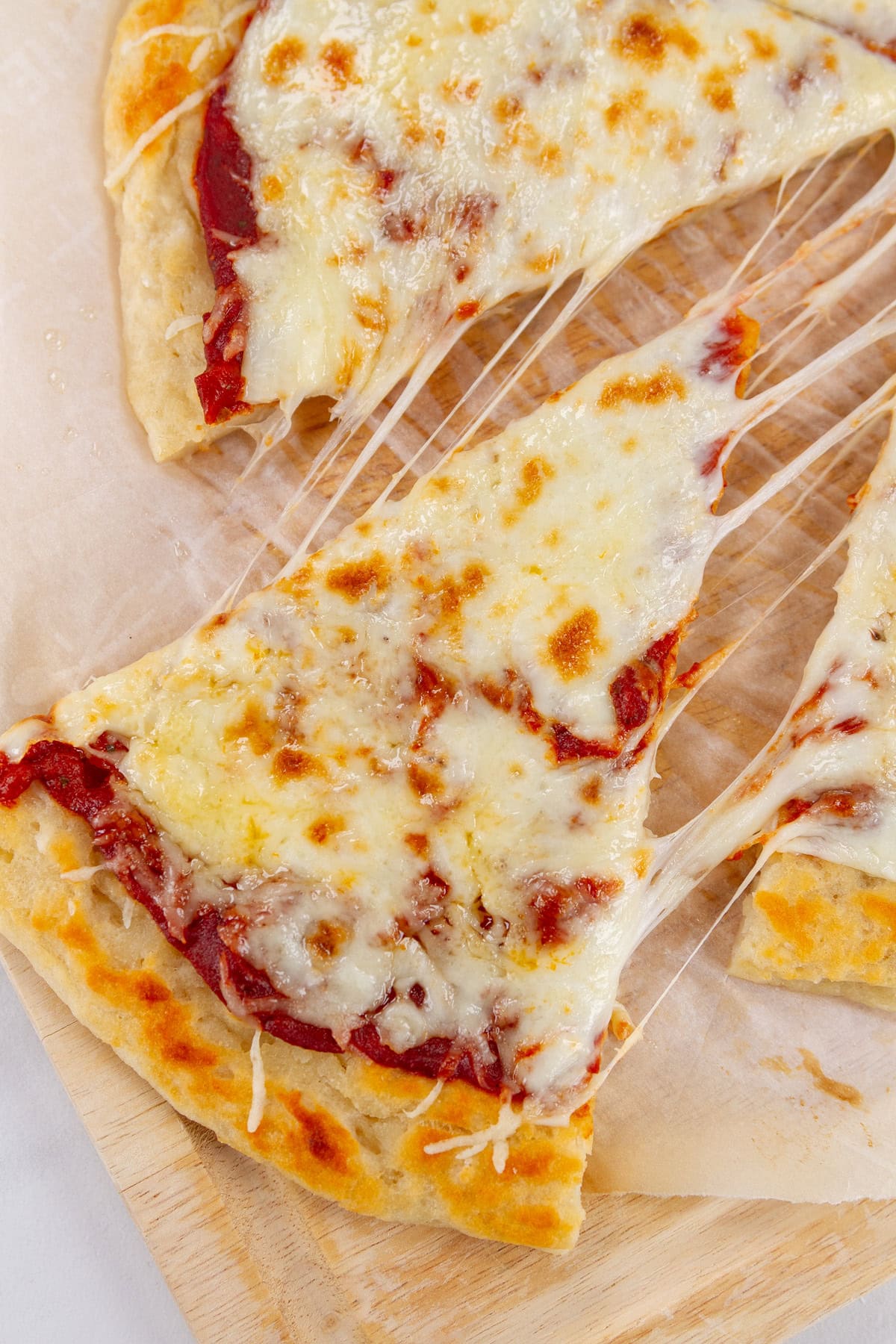 a slice of cheese with great cheese pull being taken out of the pizza.
