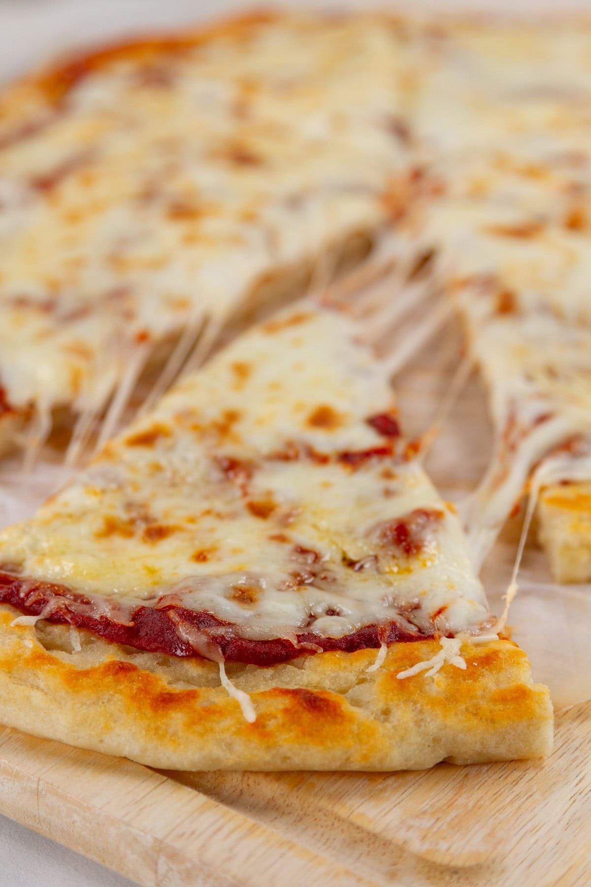 a slice of pizza being taken out of the whole pizza.