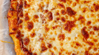 square crop looking down onto a cheese pizza.
