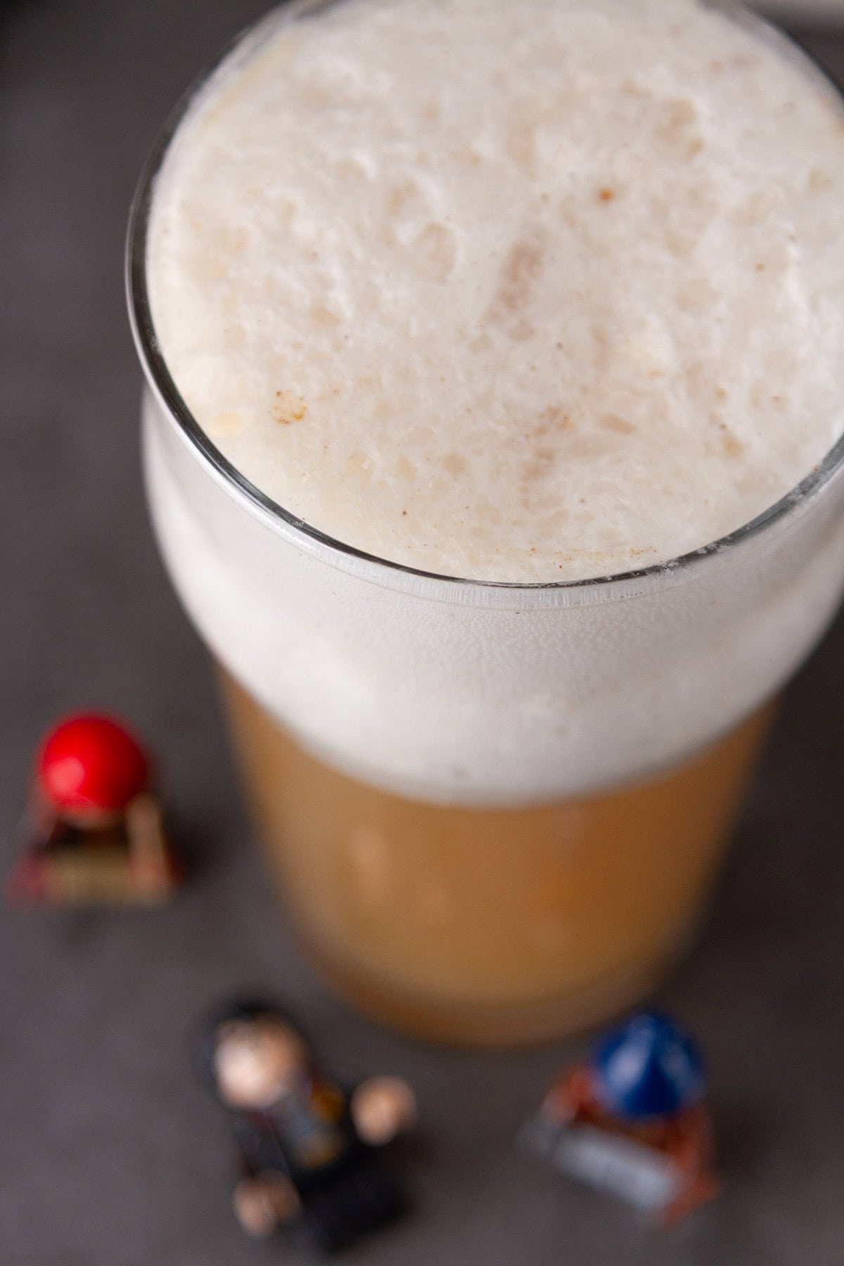 looking down onto a butterbeer with Harry Potter figures around it.