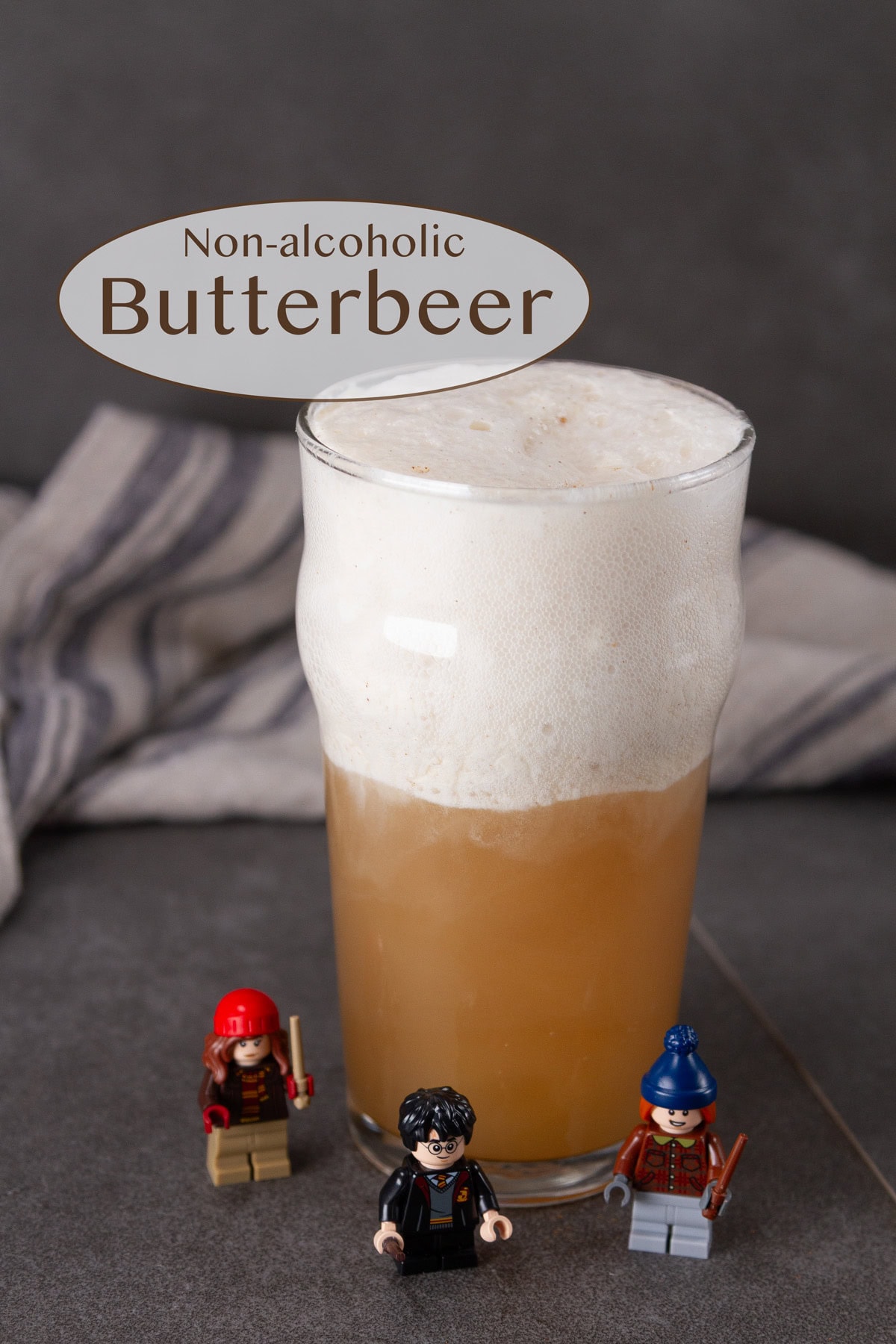 a glass of butterbeer with Lego Harry Potter figures around it.