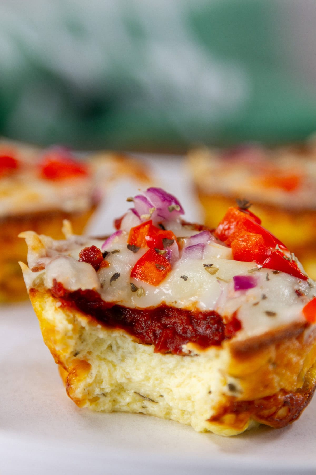 a pizza puff with a bite taken out so you can see the texture inside.