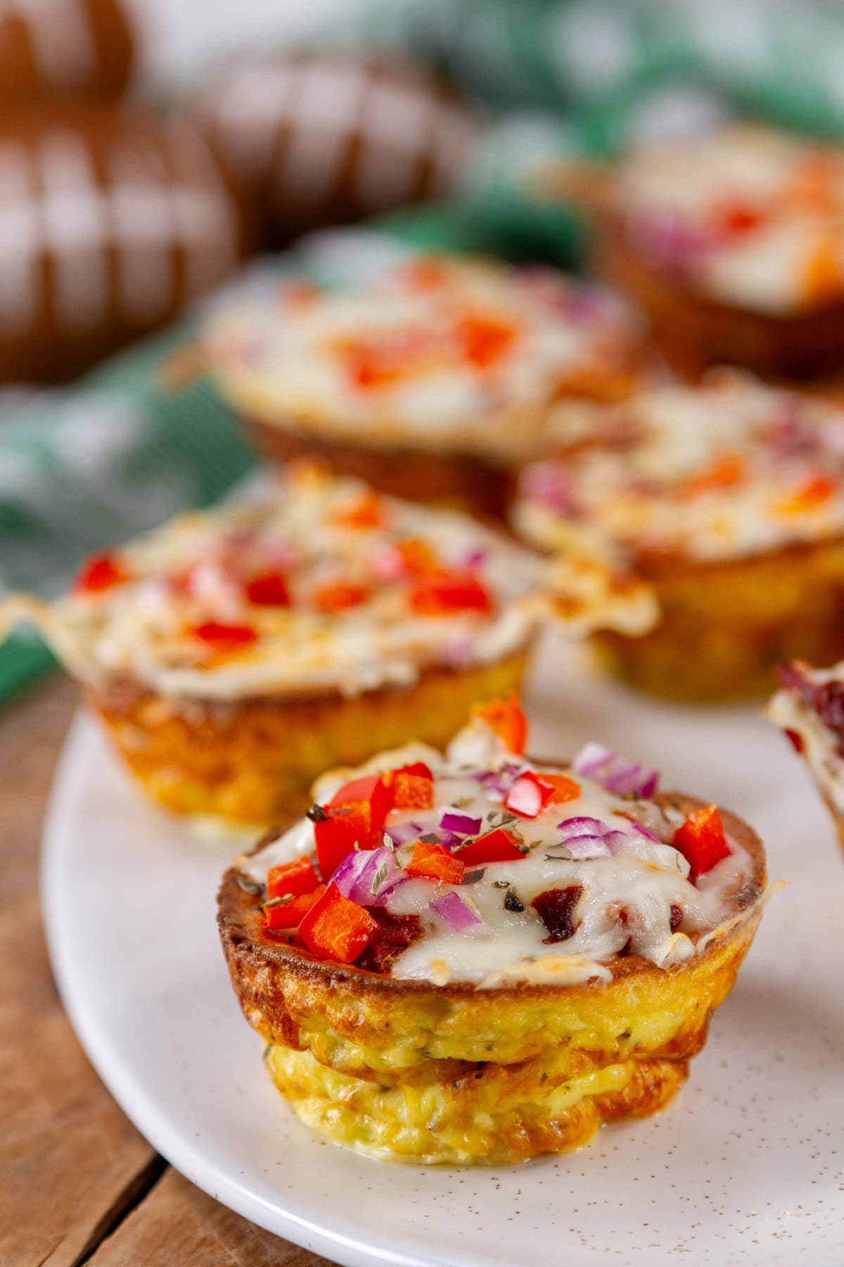 appetizers with cheese and veggies on a white tray in front of some small footballs.