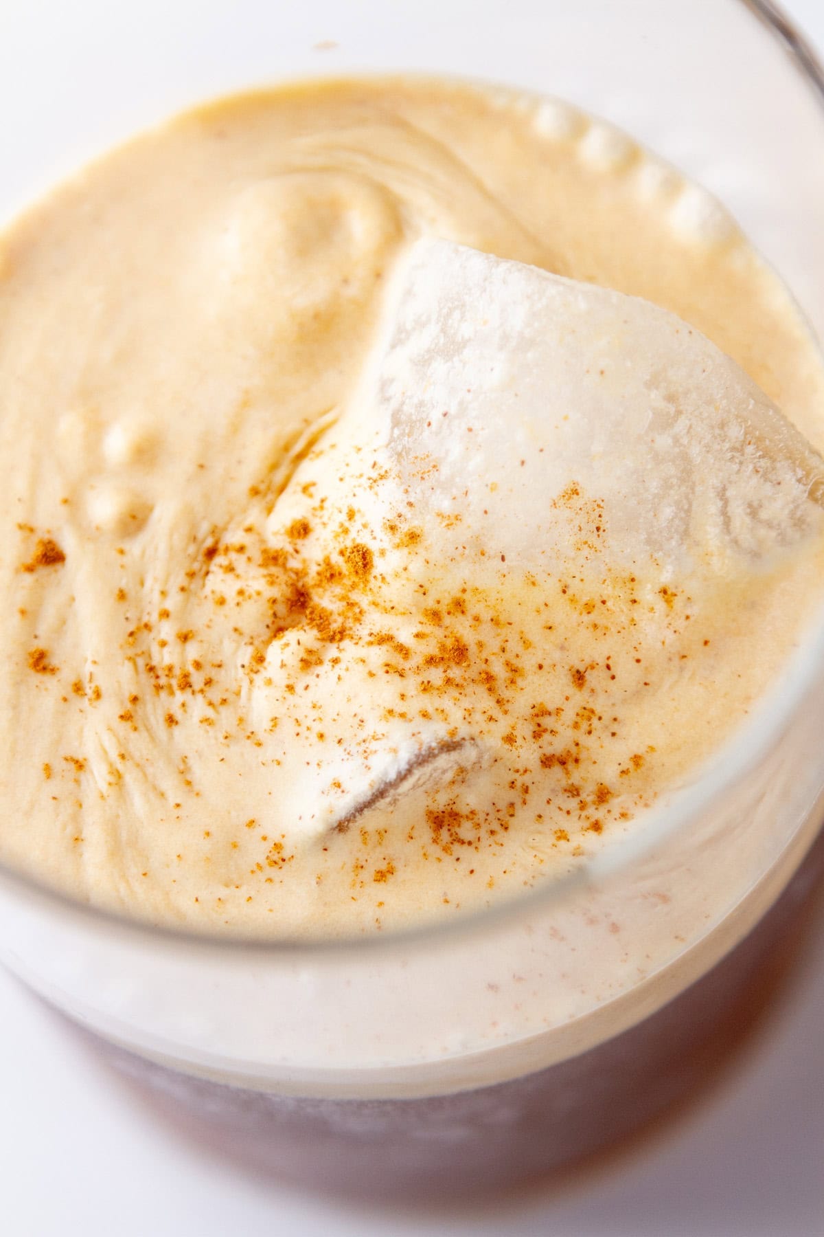 looking down onto an iced coffee topped with cold foam.