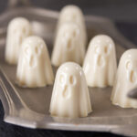 square crop of gelatin ghosts on a pewter tray.