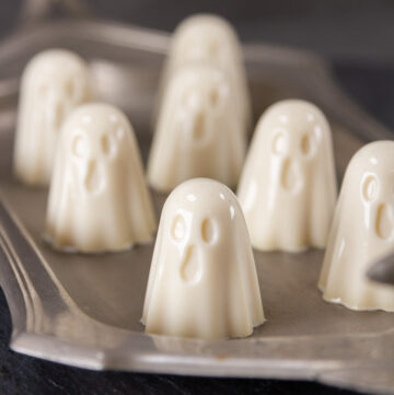 square crop of gelatin ghosts on a pewter tray.