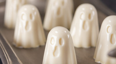 square crop of gelatin ghosts on a pewter tray.