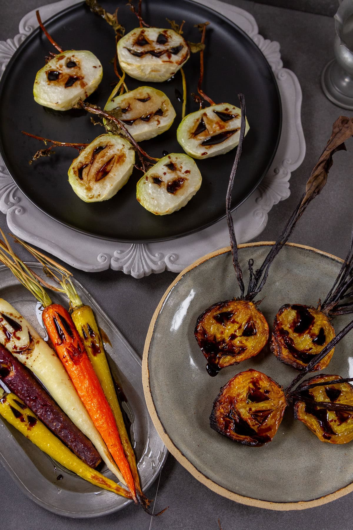 Roasted veggies in three different serving trays.