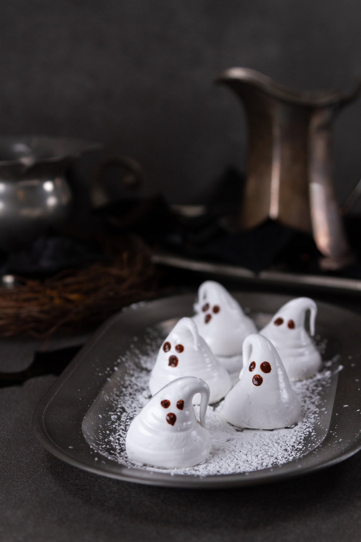 a tray of ghosts in some Halloween spooky decor.